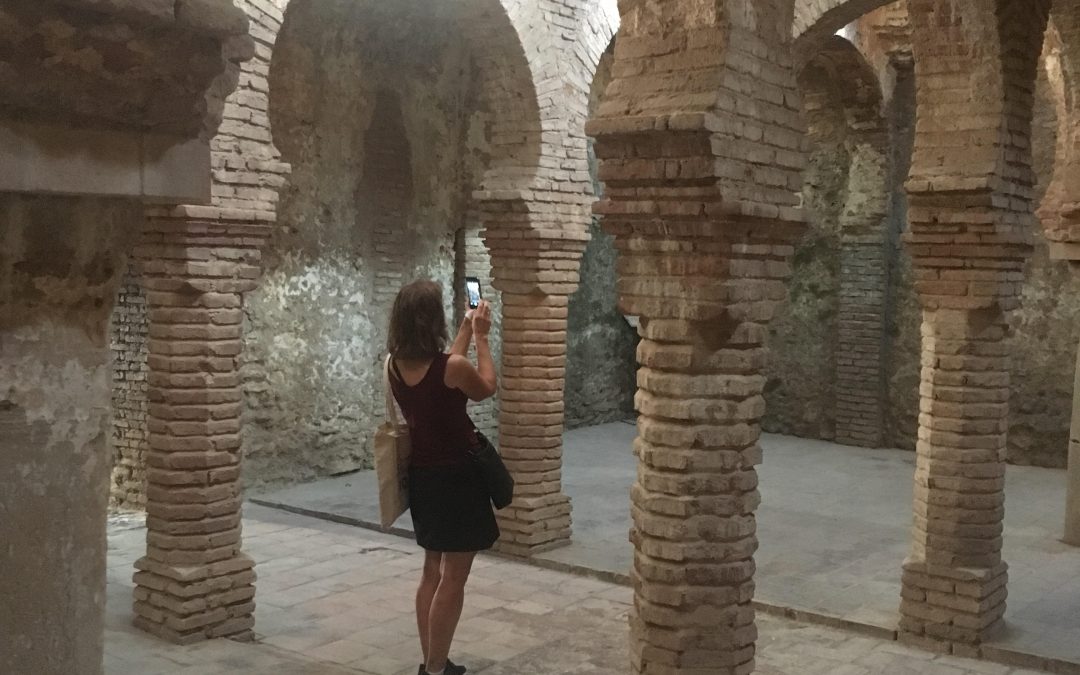 Woman taking pictures of rock columns in Spain